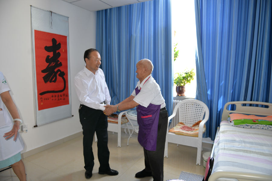 图为8月11日,地区残联党组副书记、理事长程显福看望104岁参加过抗美援朝战争的陶文根老人.JPG
